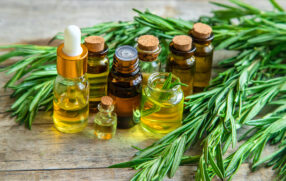 natural essential oils on wooden bench surrounded by leaves