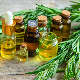 natural essential oils on wooden bench surrounded by leaves