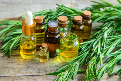 natural essential oils on wooden bench surrounded by leaves