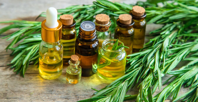 natural essential oils on wooden bench surrounded by leaves